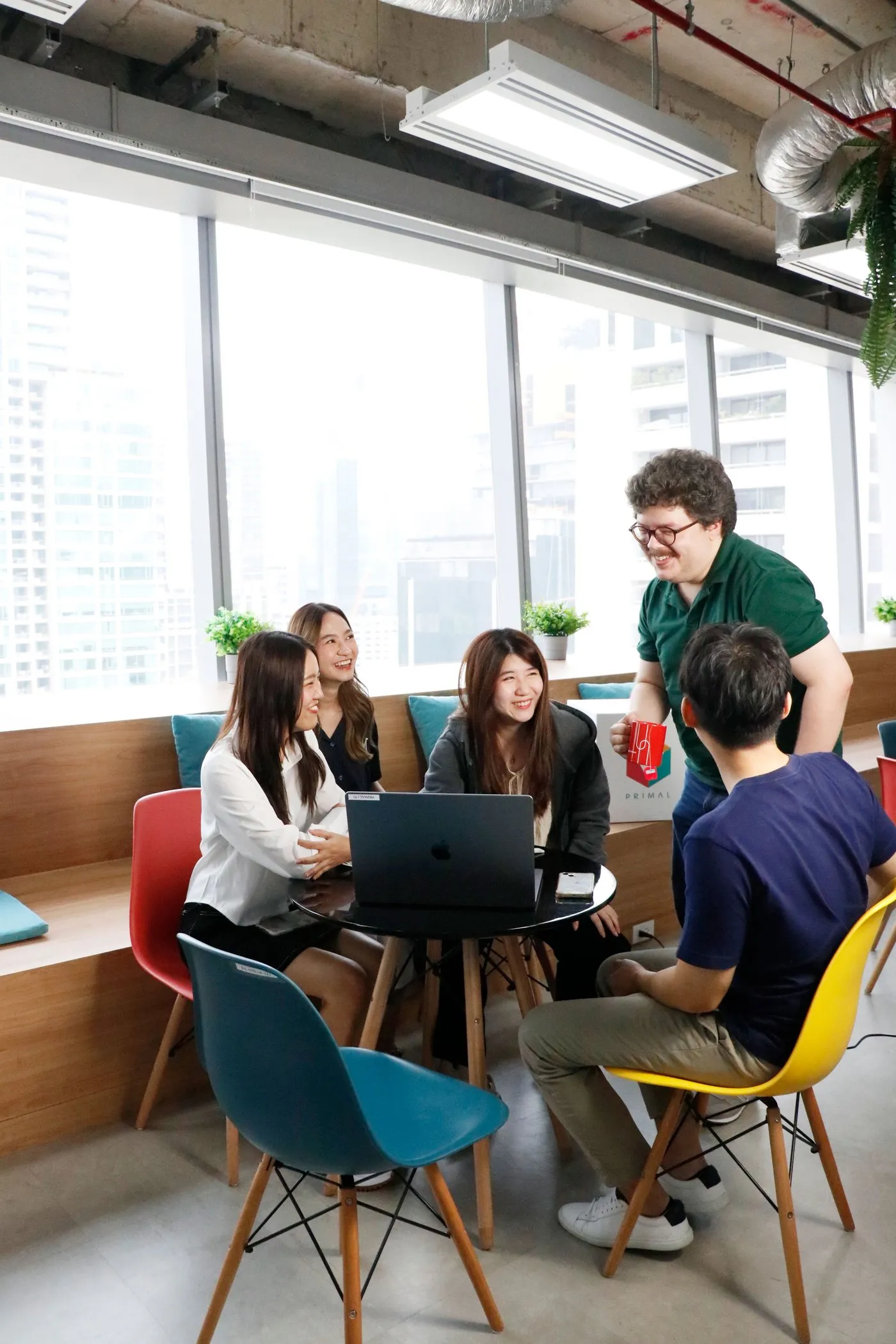 A Primal team in a working session around a table in the Bangkok office