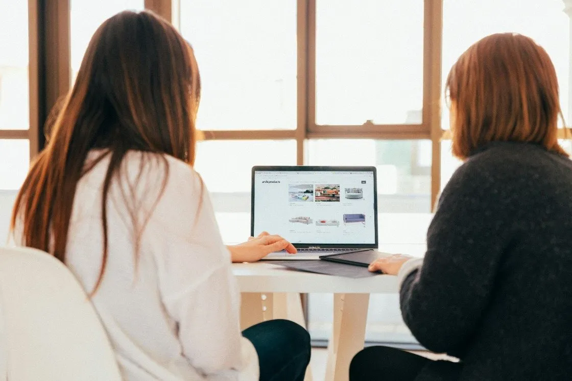 Two Primal colleagues reading a report on a laptop